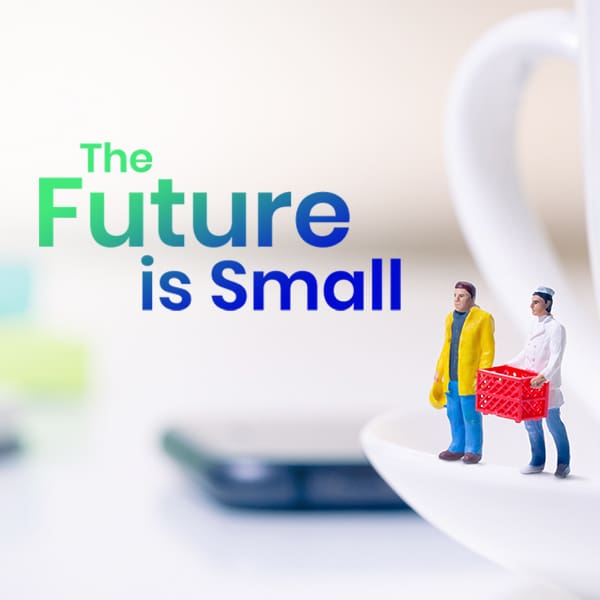 Two miniature figures with shopping cart next to smartphone with text "The Future is Small